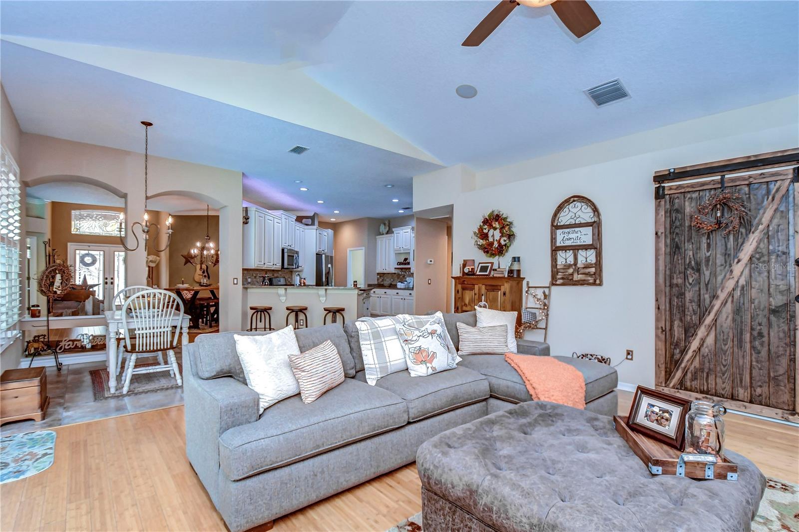 This cozy living area boasts a rustic sliding barn door and an inviting open-plan layout.