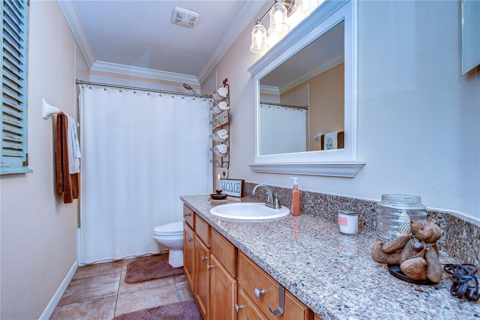 Step into this stylish bathroom, complete with granite countertops