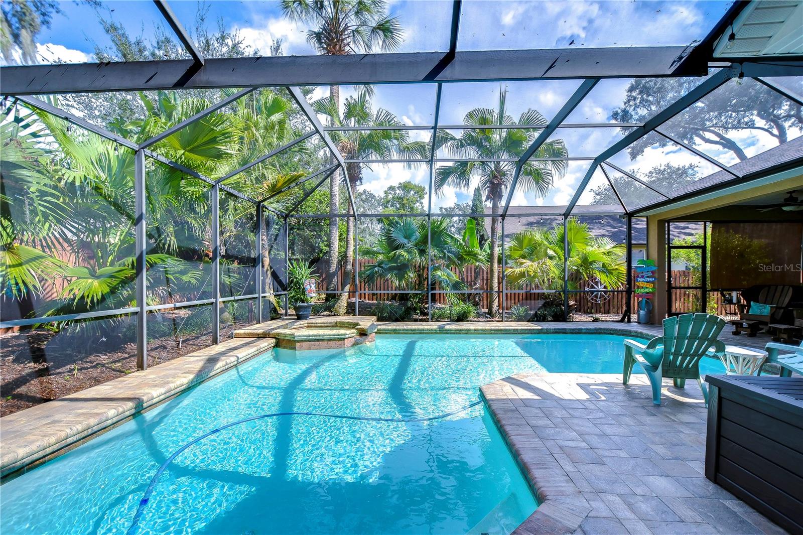 Escape to your private tropical oasis with this stunning screened-in pool.