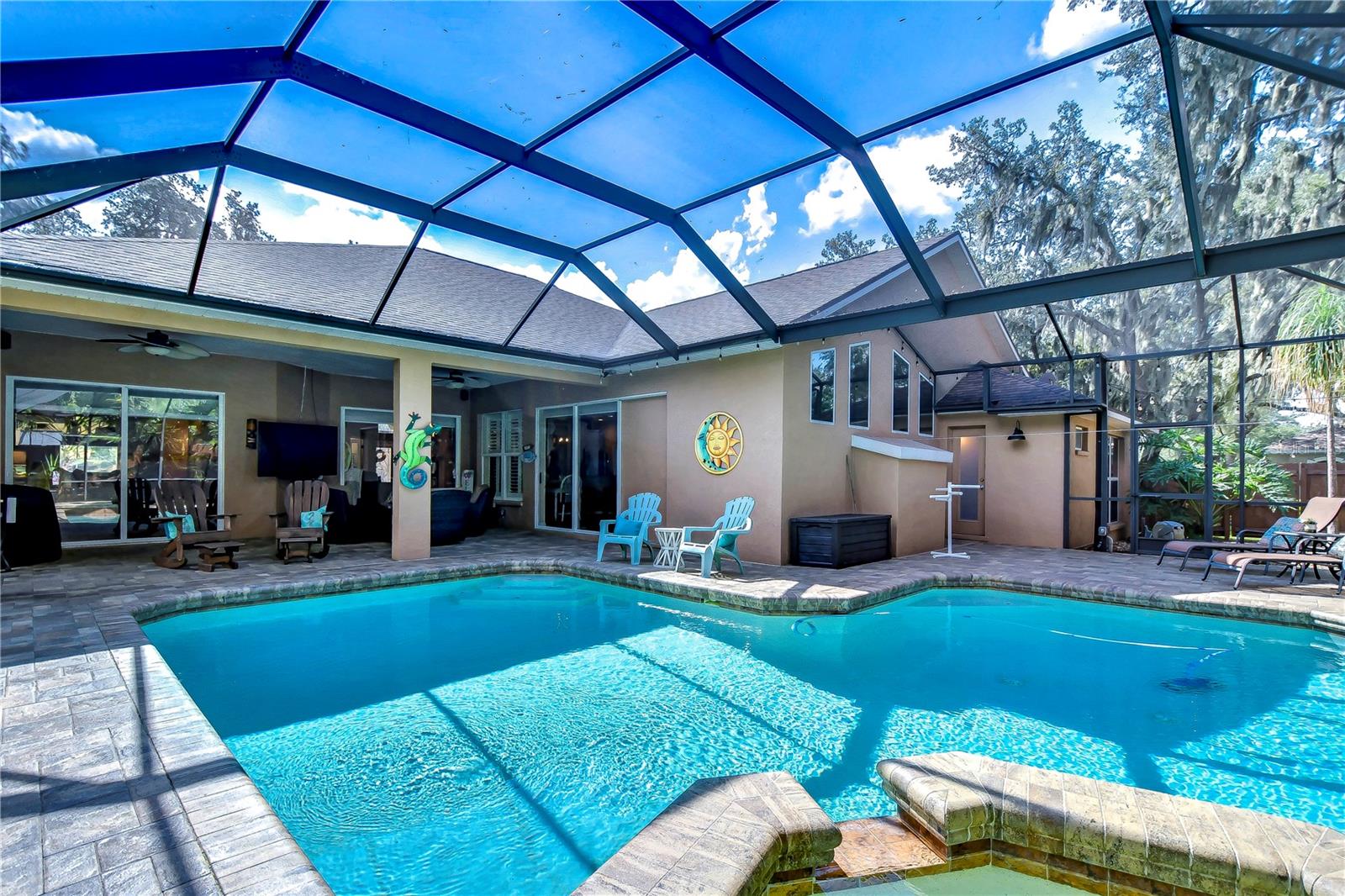 Dive into relaxation with this stunning screened-in patio and pool oasis!