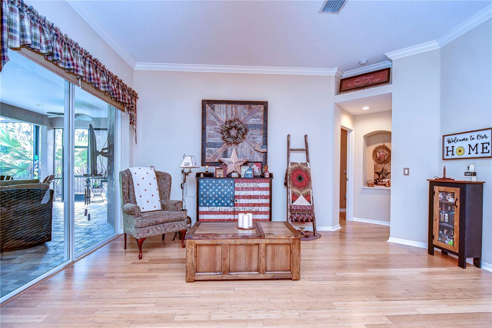 Cozy and inviting, this charming space offers a seamless transition to the patio through elegant sliding doors.