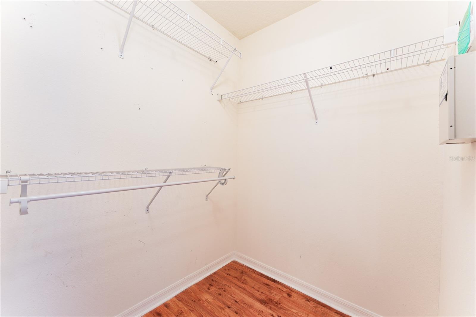 Primary bedroom walk in closet