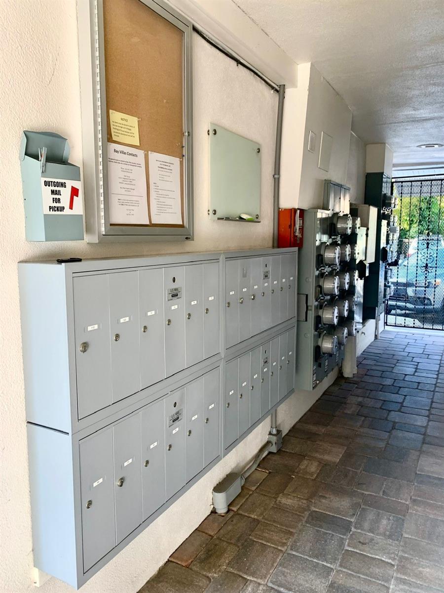 Community Mailbox leads to back gated entrance where deeded parking space is located for this condo