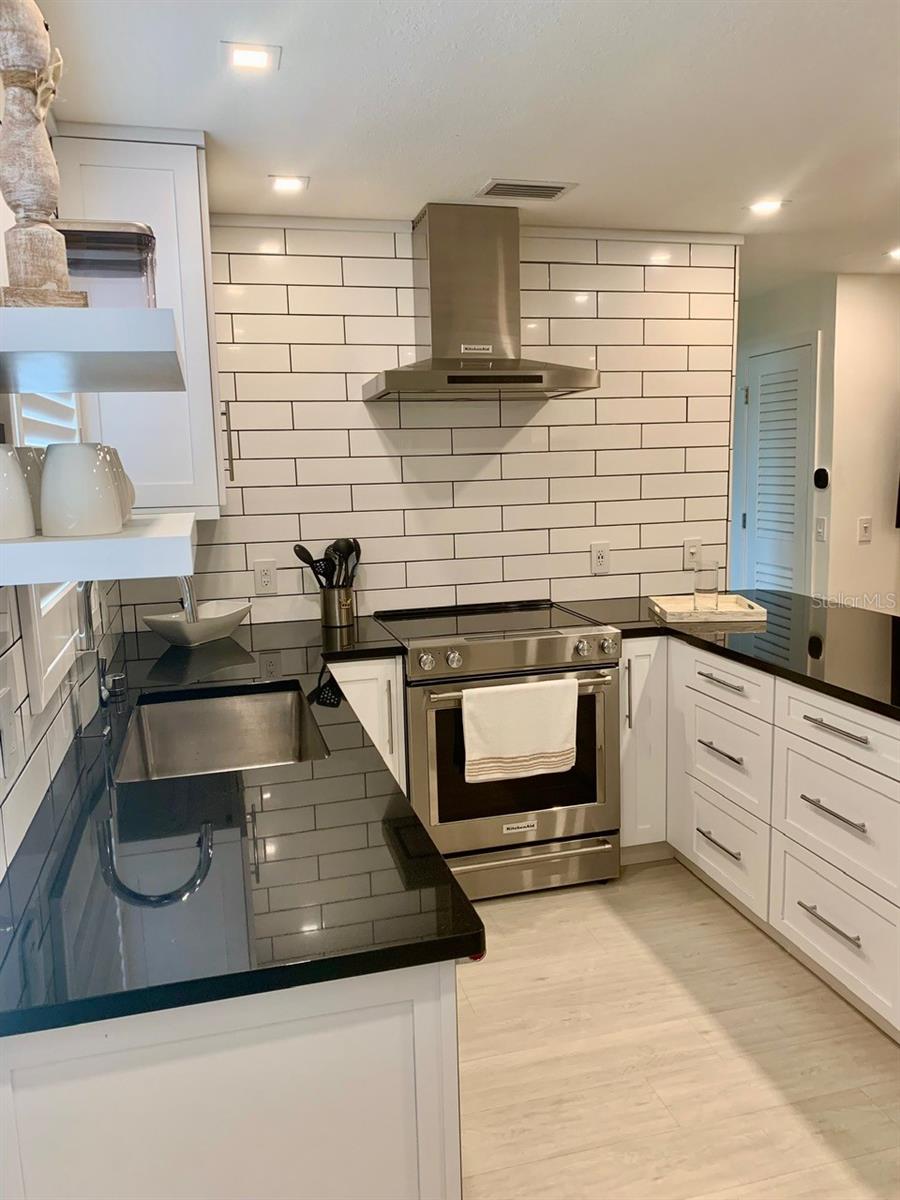 Kitchen with black granite countertops