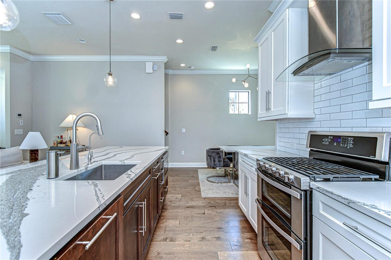 This exquisite kitchen invites culinary creativity with its pristine countertops and state-of-the-art appliances