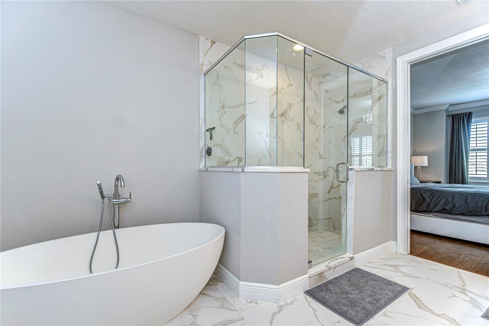 Indulge in  freestanding tub and luxurious marble accents.