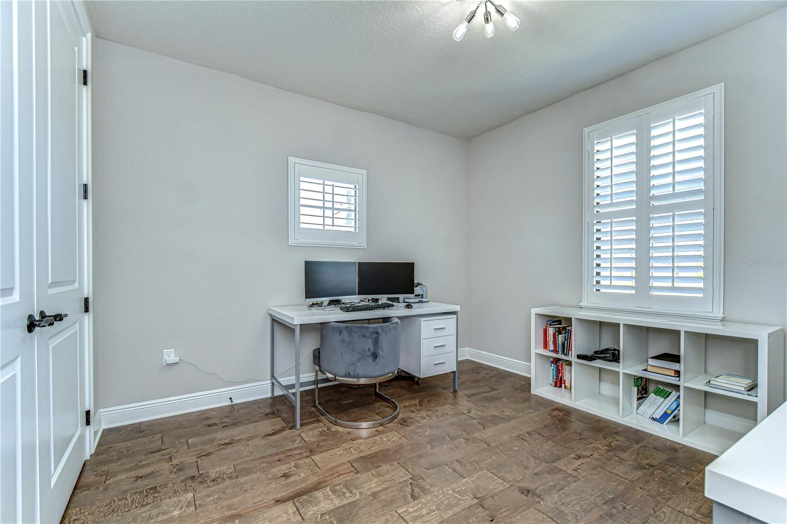 Step into this wonderful bedroom that features ample natural light through elegant shutters