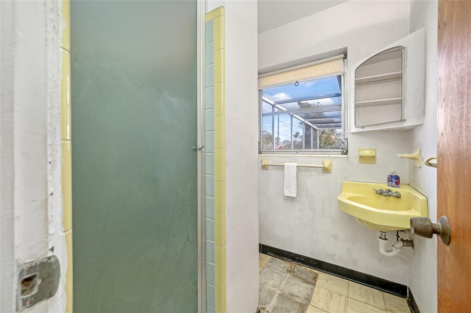 Bathroom located in the Garage with Shower.