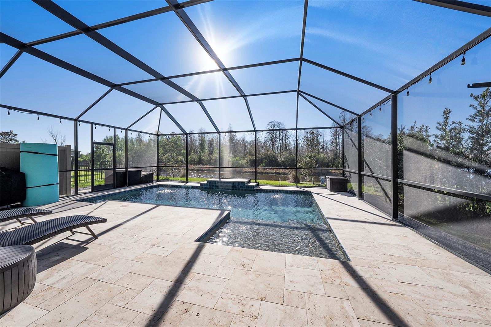 Expansive travertine cool deck is perfect for outdoor entertaining!