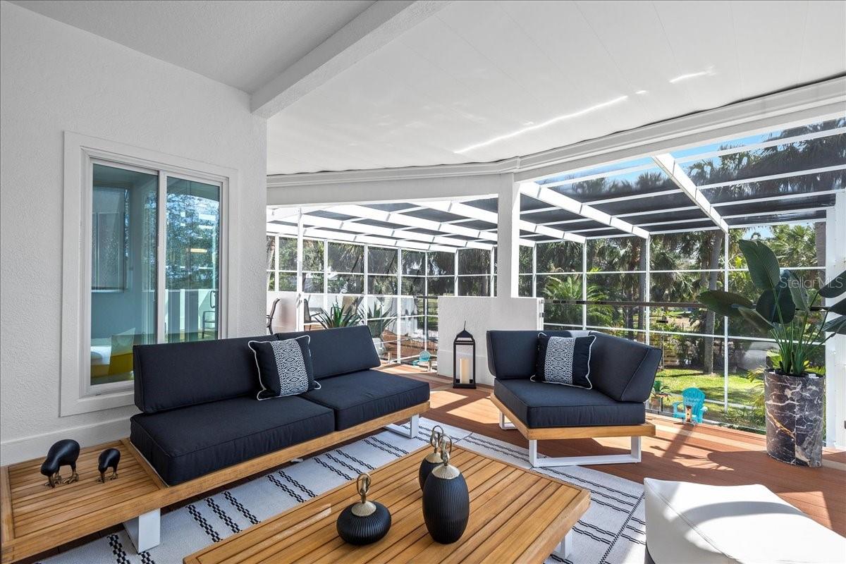 2nd floor patio overlooking the pool with 'invisible' floating glass panel railing