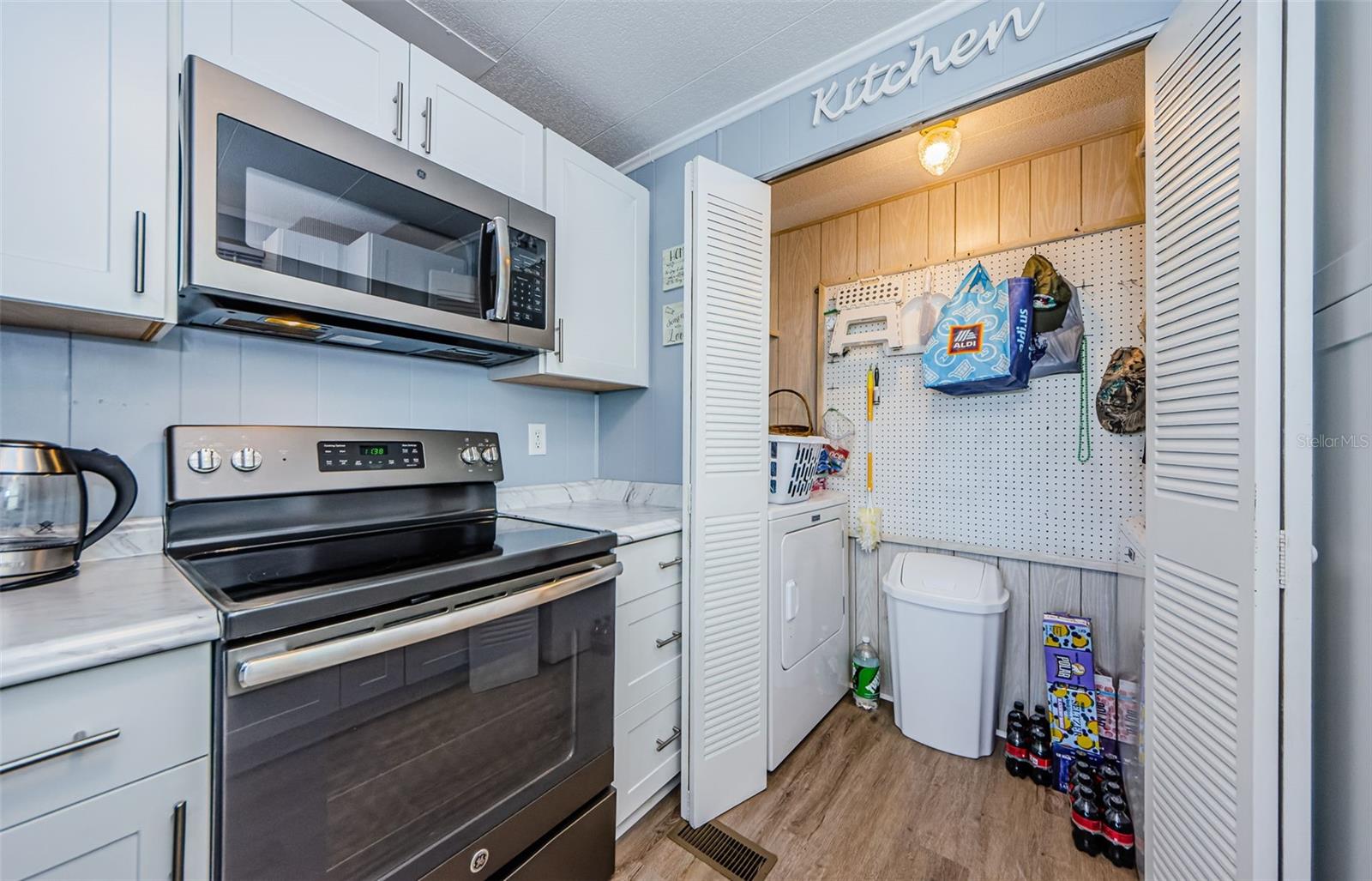 laundry closet with full sized washer/dryer & additonal storage space