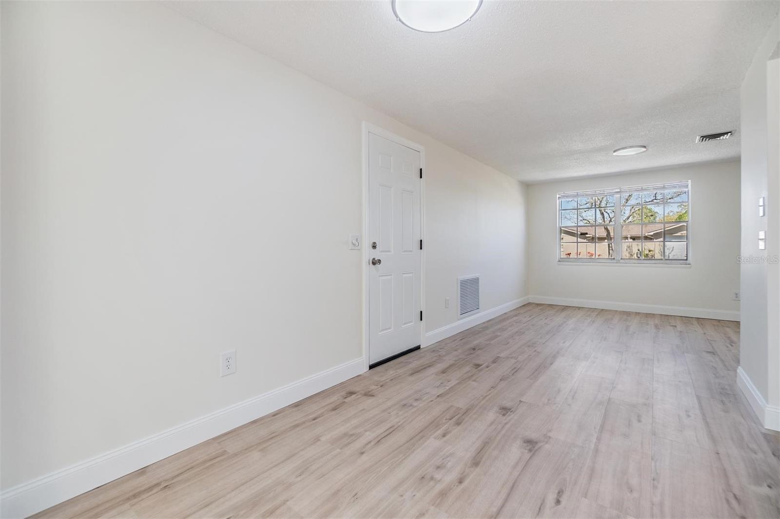 DINING ROOM AND LIVING ROOM (NEW GARAGE SERVICE DOOR)