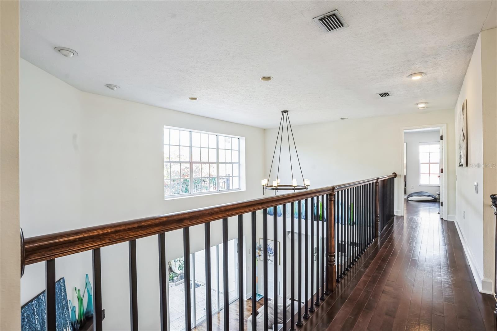 Walkway from 2 bedrooms upstairs to the private primary bedroom