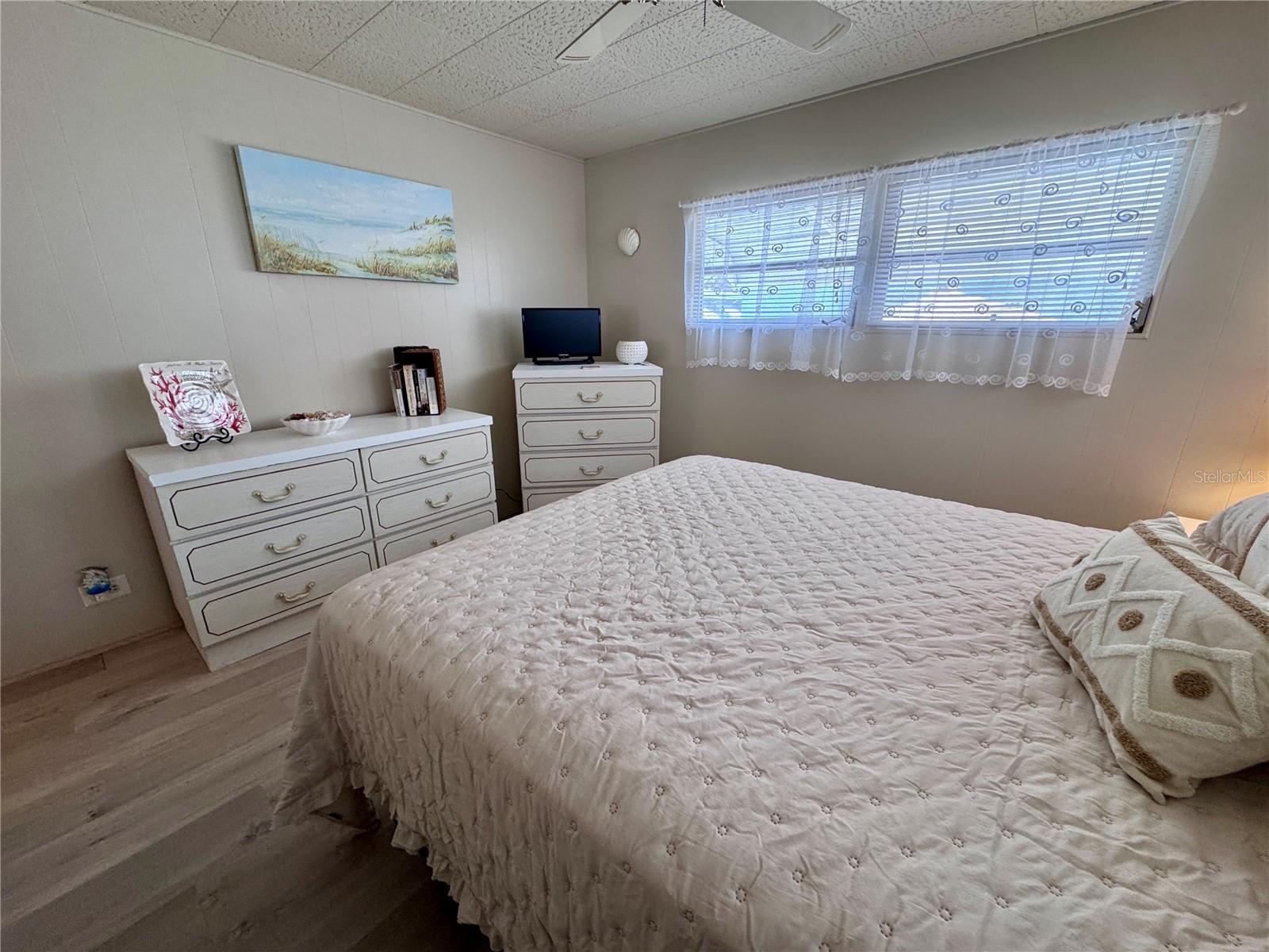 Guest bedroom with vinyl plank flooring.