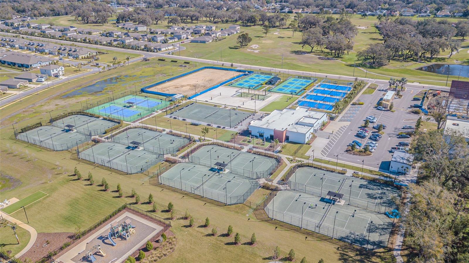 Amenity center with clubhouse, gym, and huge pool featuring sunshelf