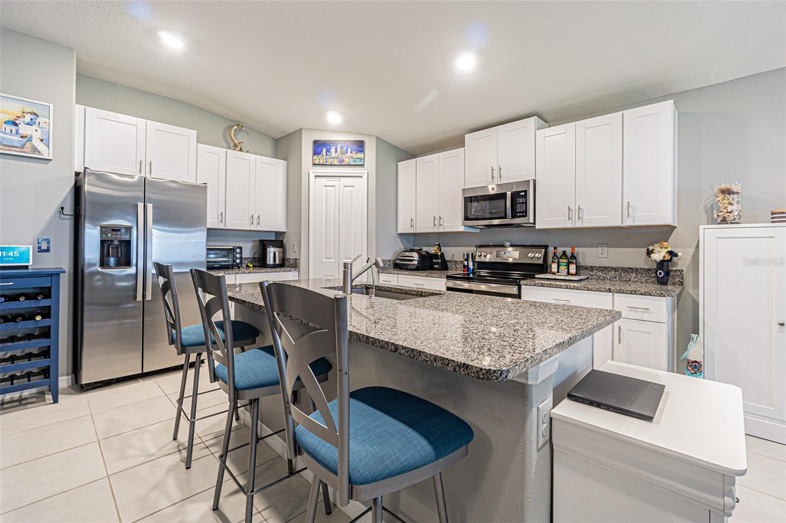 Chef's kitchen with large island and spacious corner pantry