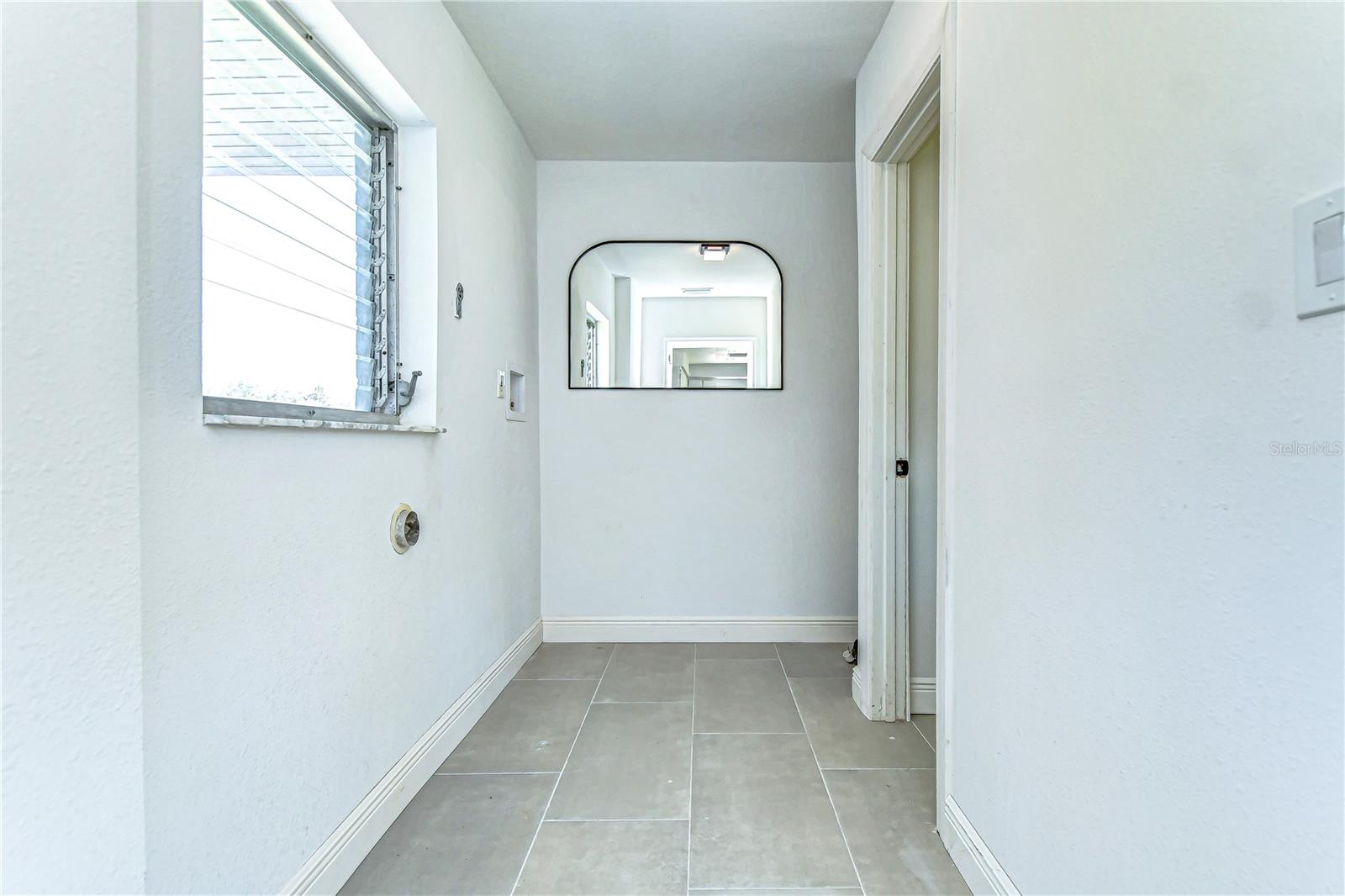 This inviting corridor connects to the rest of a charming home, promising the perfect blend of comfort and contemporary aesthetics.