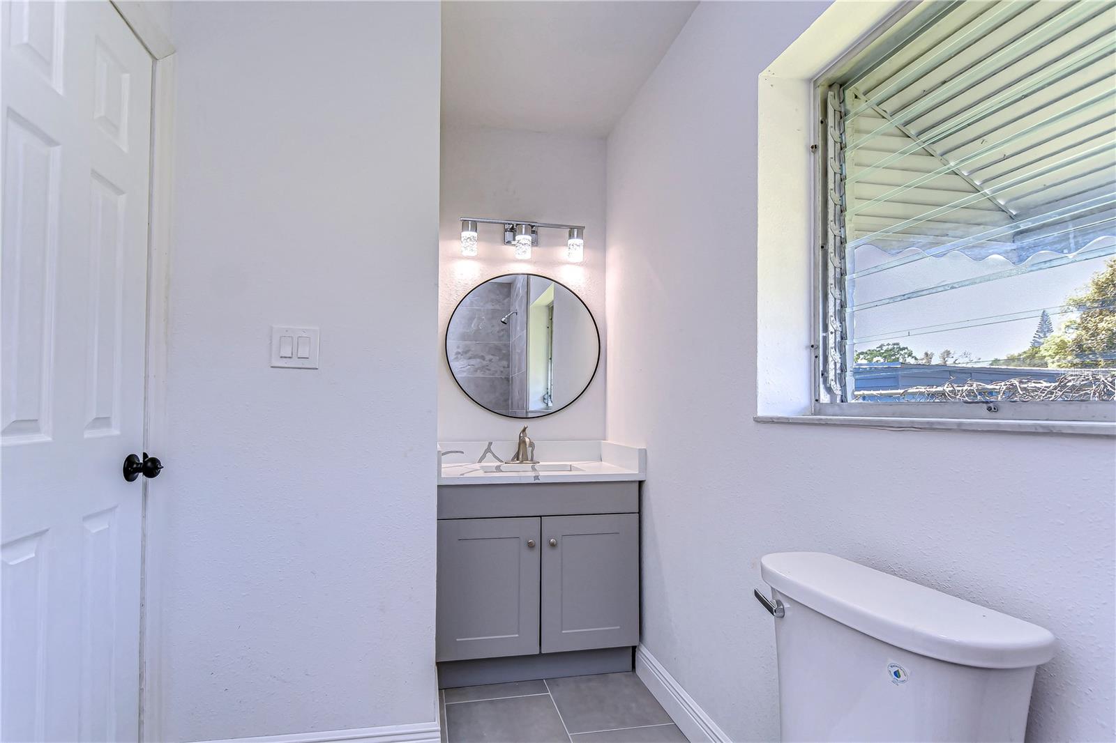 Step into this sleek bathroom, where simplicity meets sophistication.