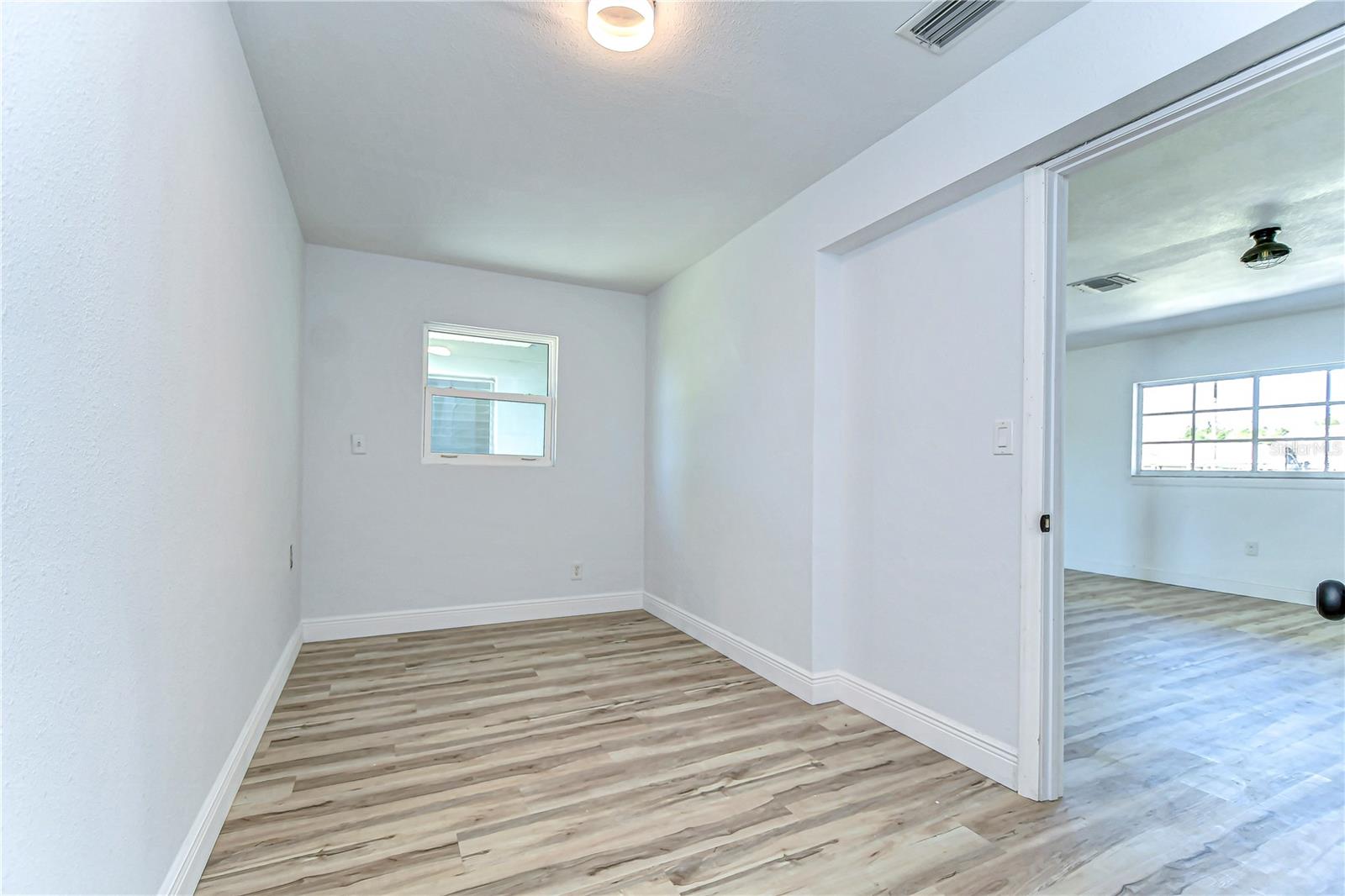 This versatile bedroom boasts sleek floors and soft lighting, providing a blank canvas for your creative touch.