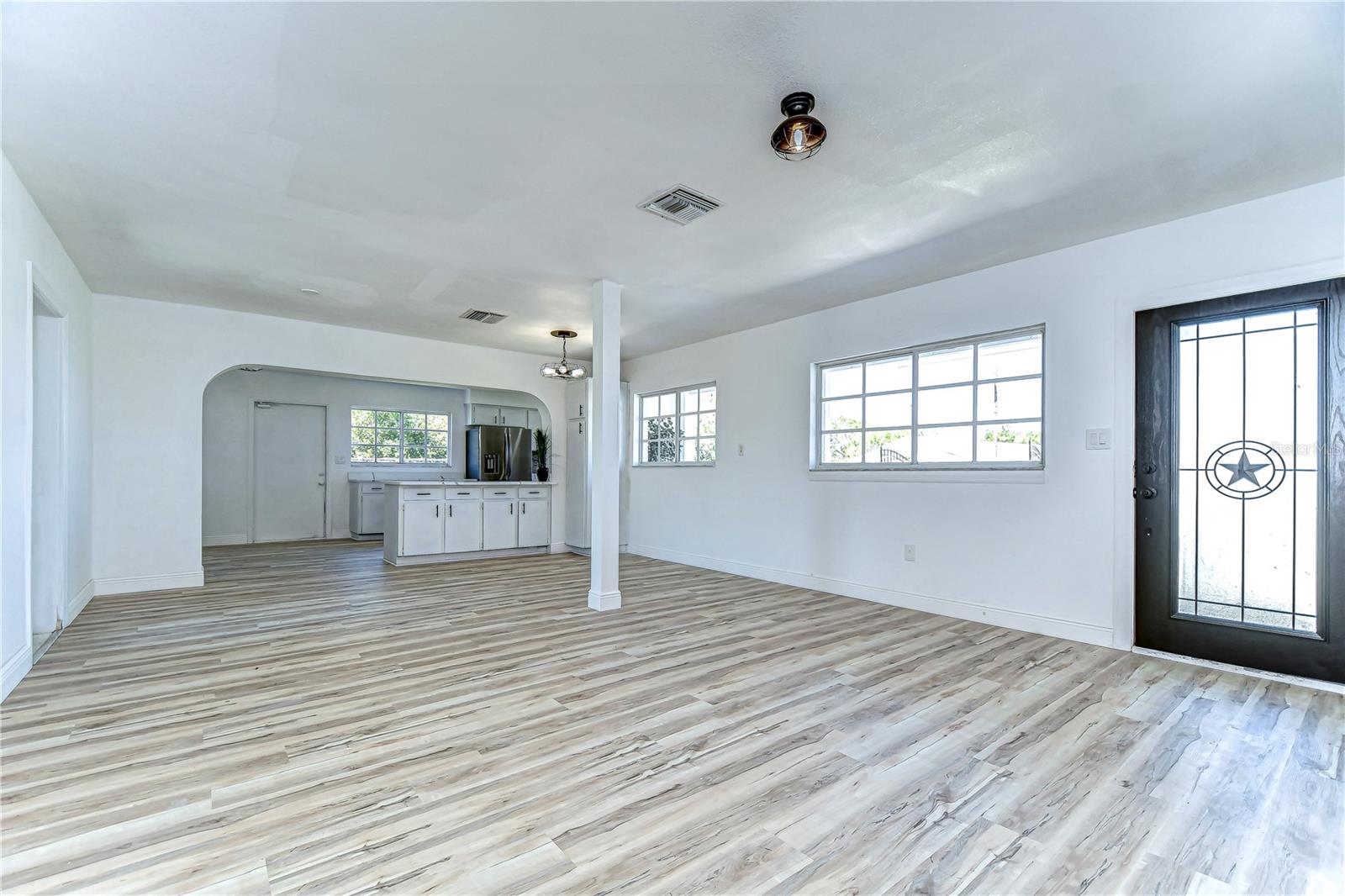 Step into a realm of possibilities with this bright and airy room, featuring sleek flooring that whispers elegance.