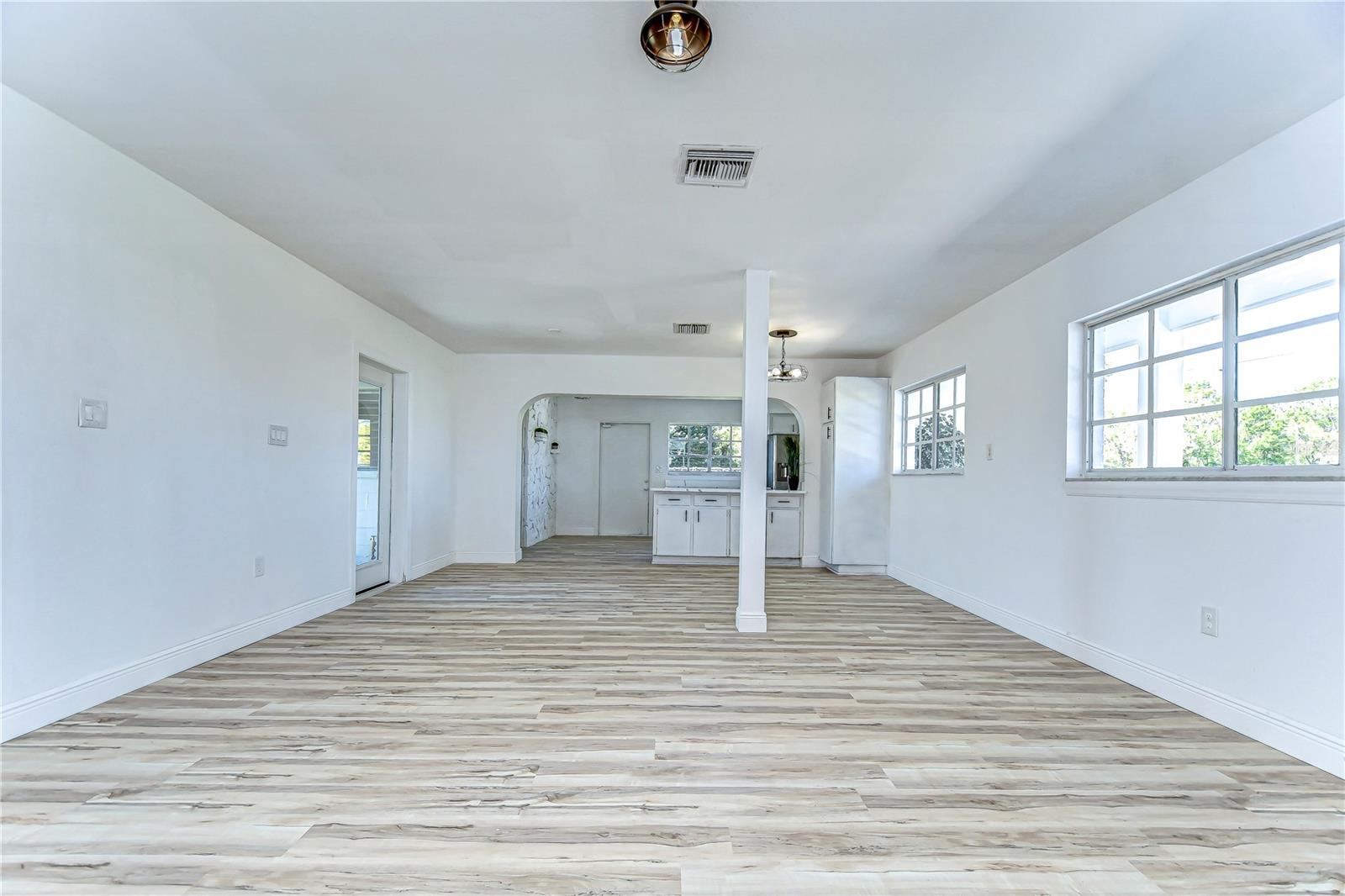 Step into this spacious home featuring beautifully updated flooring that flows effortlessly into a bright, inviting kitchen area.