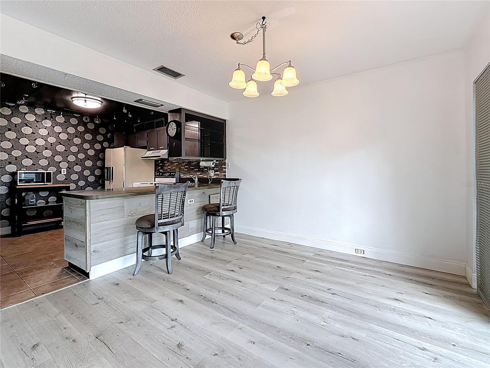 View into dining area/breakfast bar/kitchen from the bonus sitting area/office space.