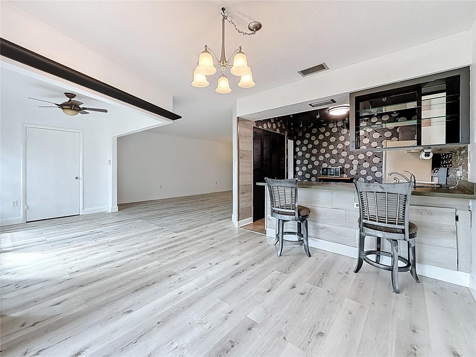 Your back is to the sliding glass door off the dining area, looking back towards sitting area & kitchen. The black "line" across the top is actually a shelf that goes around that room.