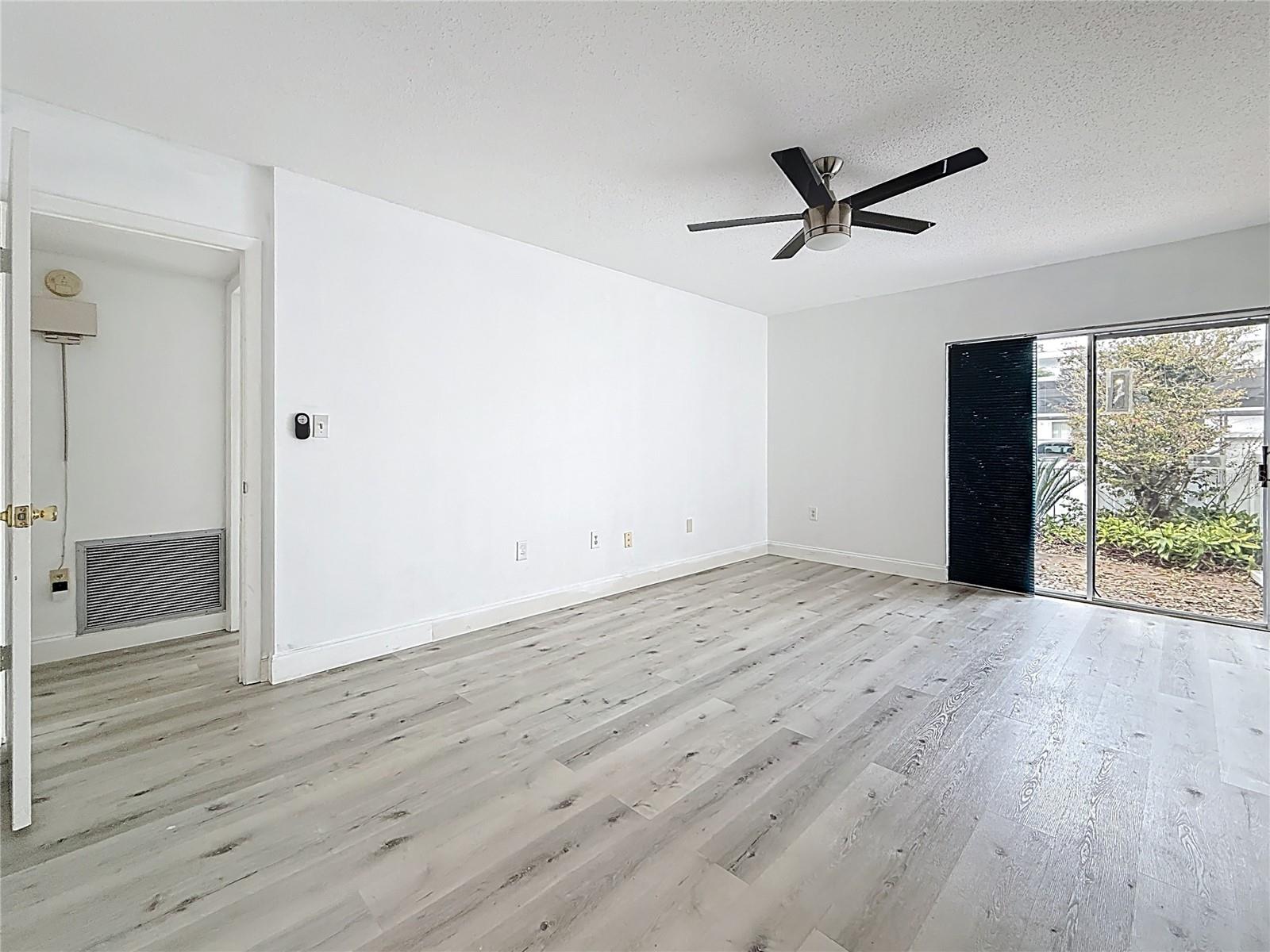 Entrance into primary bedroom via the primary bath. The main door into the bedroom is over t o your left. The sliding glass doors lead to the quaint front patio.