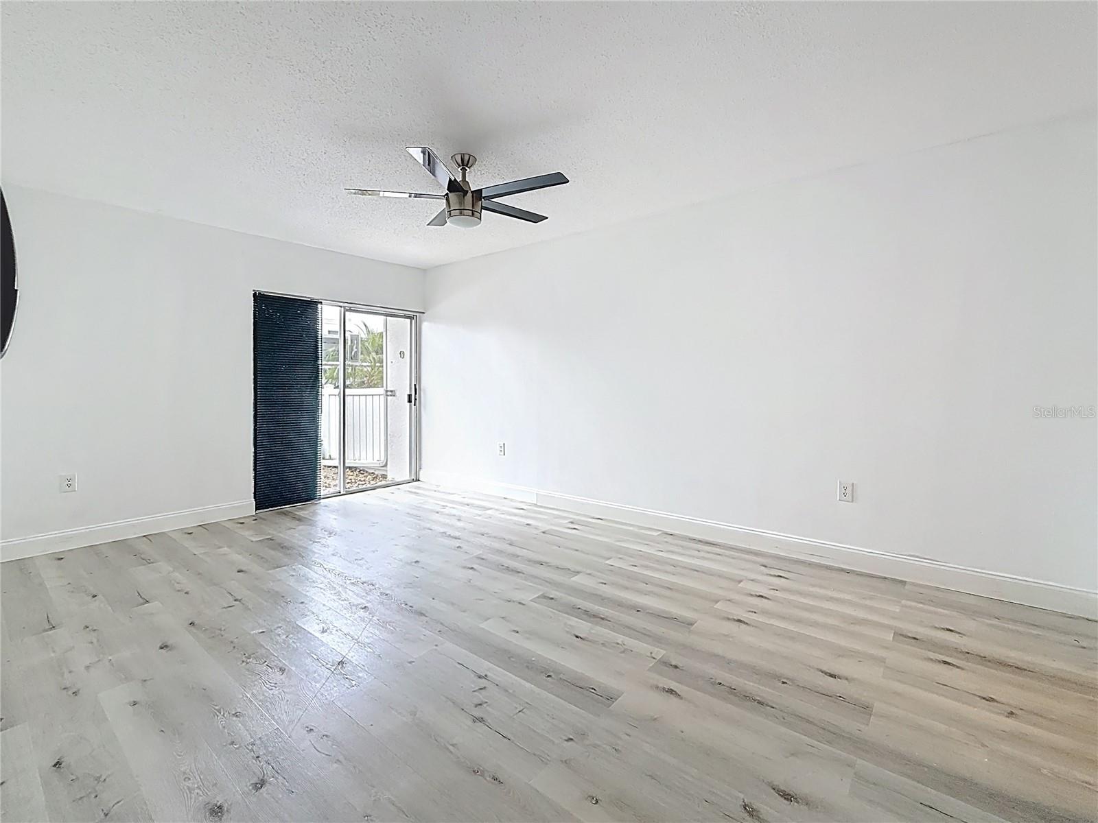 View from the doorway of the primary bedroom. This bedroom is HUGE! It previously housed an over-sized California King full bedroom suite, plus large TV cabinet.