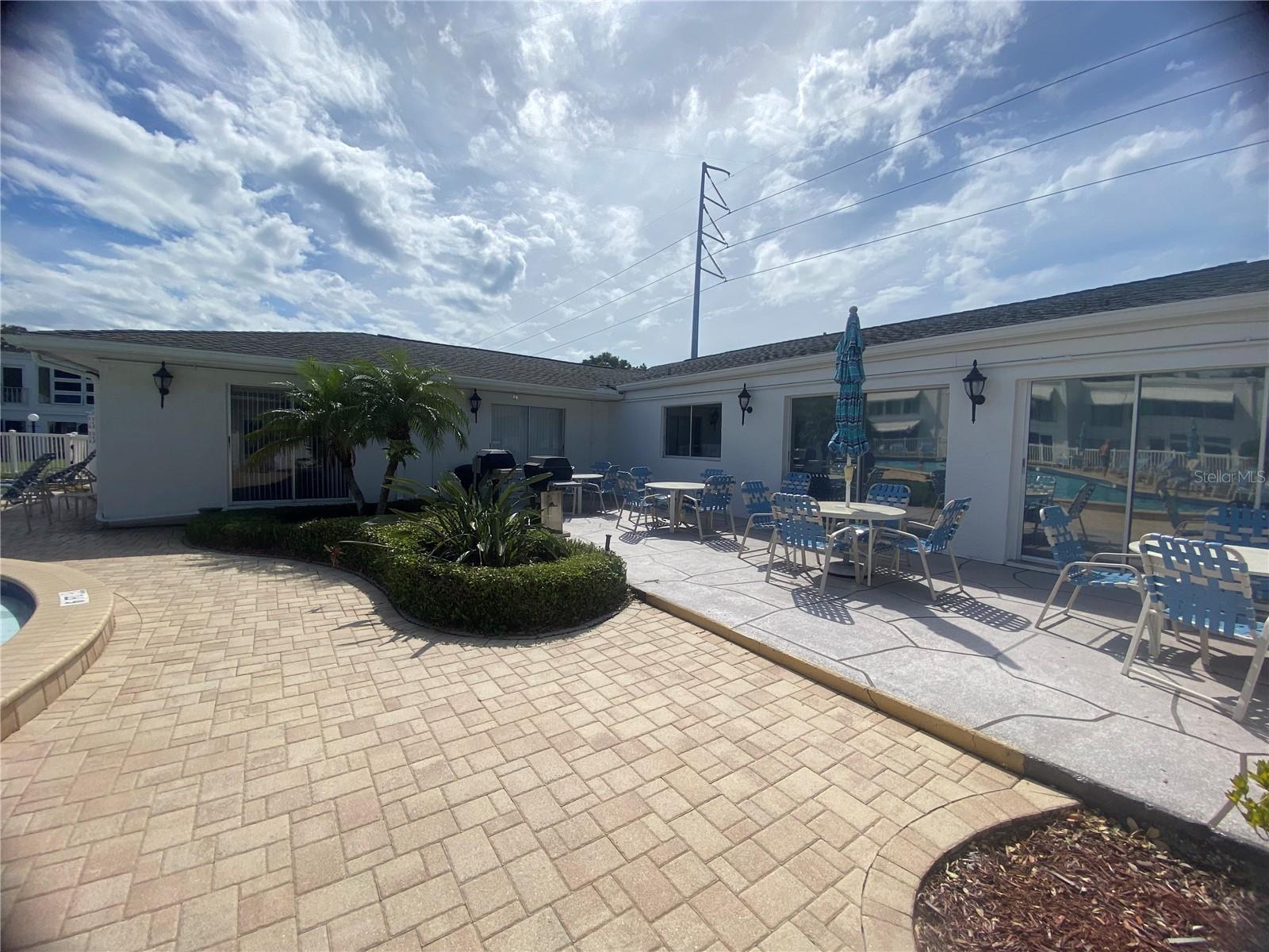 Clubhouse BBQ grills and patio tables.