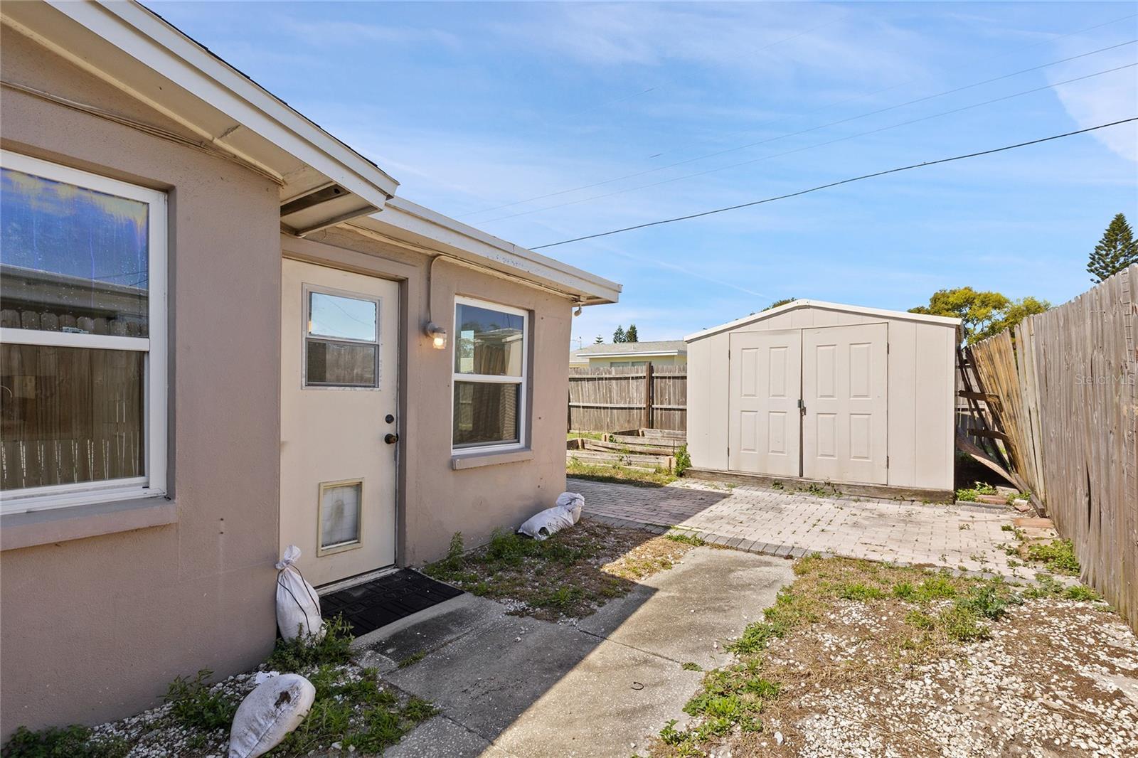 Storage Shed with lots of paved areas at the back yard