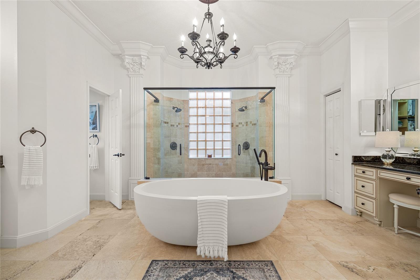 Deep Soaking tub with dual walk in showers behind