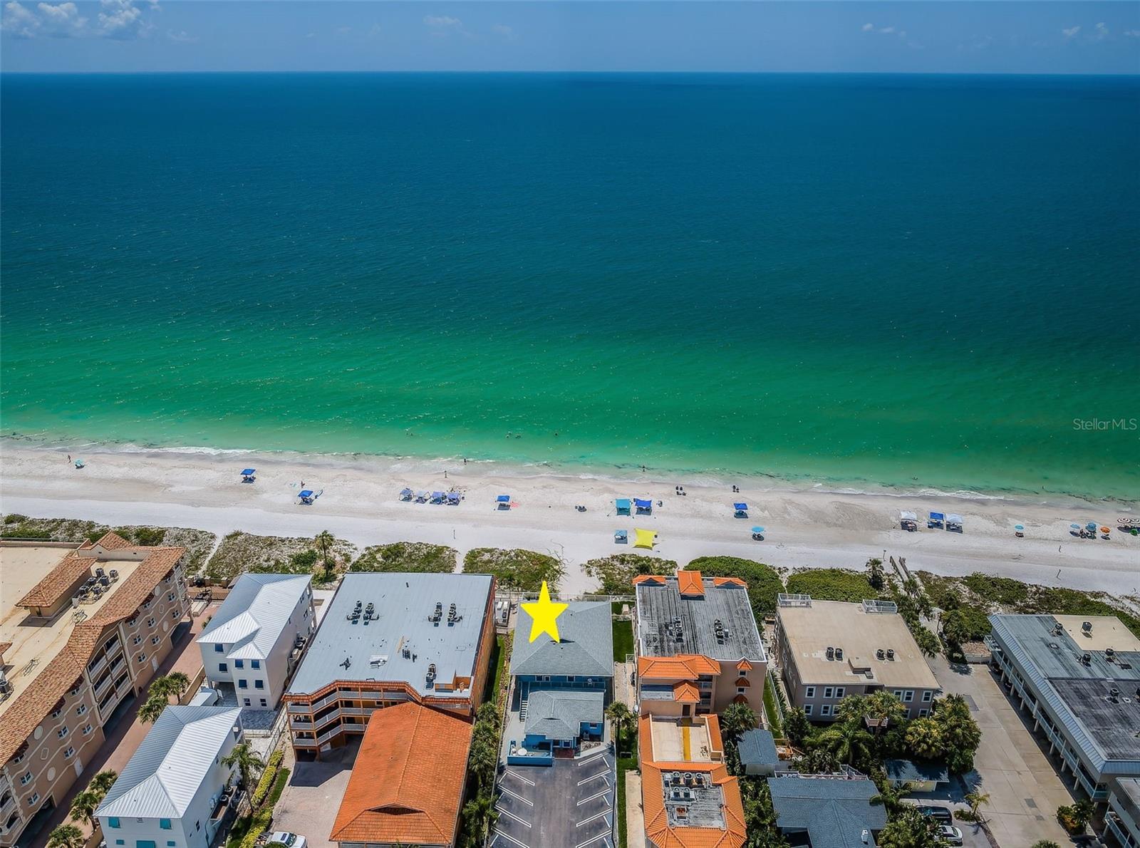 . Aerial of Beach and Le Mar Complex.. The Parking Lot Stripes are Behind a Secured Remote Controled Gate..