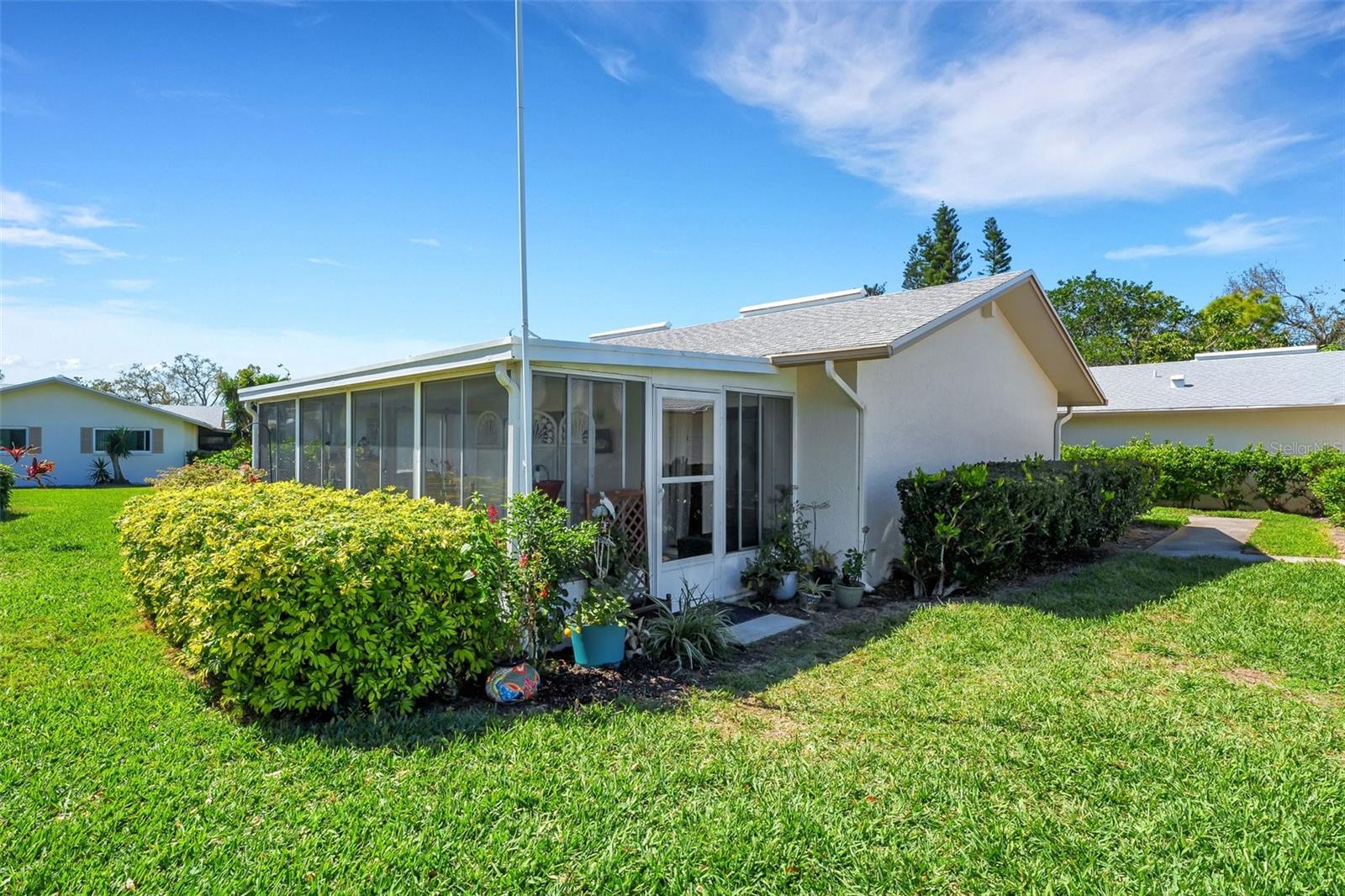 Nestled in a peaceful cul-de-sac, The rear of the property features an inviting enclosed porch, providing a cozy and sheltered entry point often used by homeowners for ease of access.