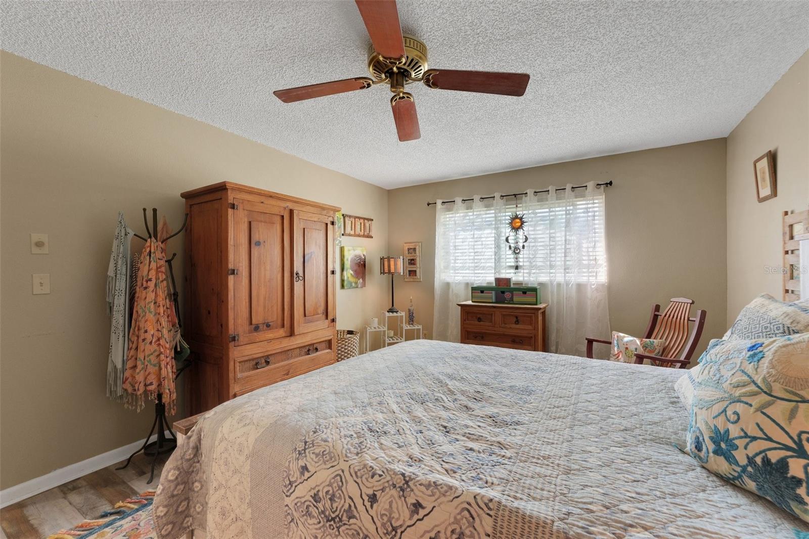 This view of the master bedroom from the right side of the bed captures the spacious layout and tranquil ambiance. The room offers a generous amount of space, perfect for creating your ideal retreat.