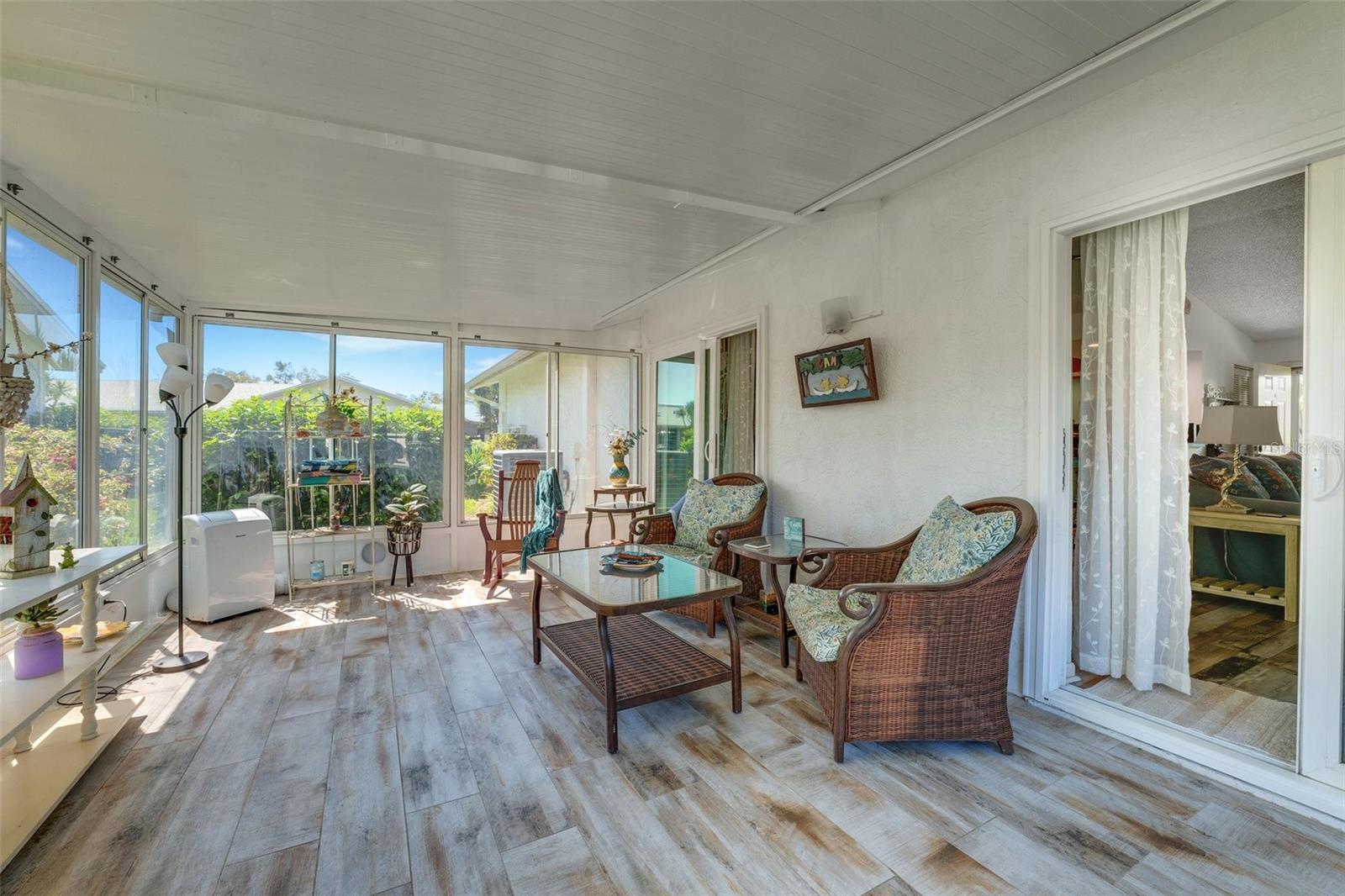 Step into comfort: This enclosed porch offers a seamless transition into the spacious main living area, perfect for year-round enjoyment