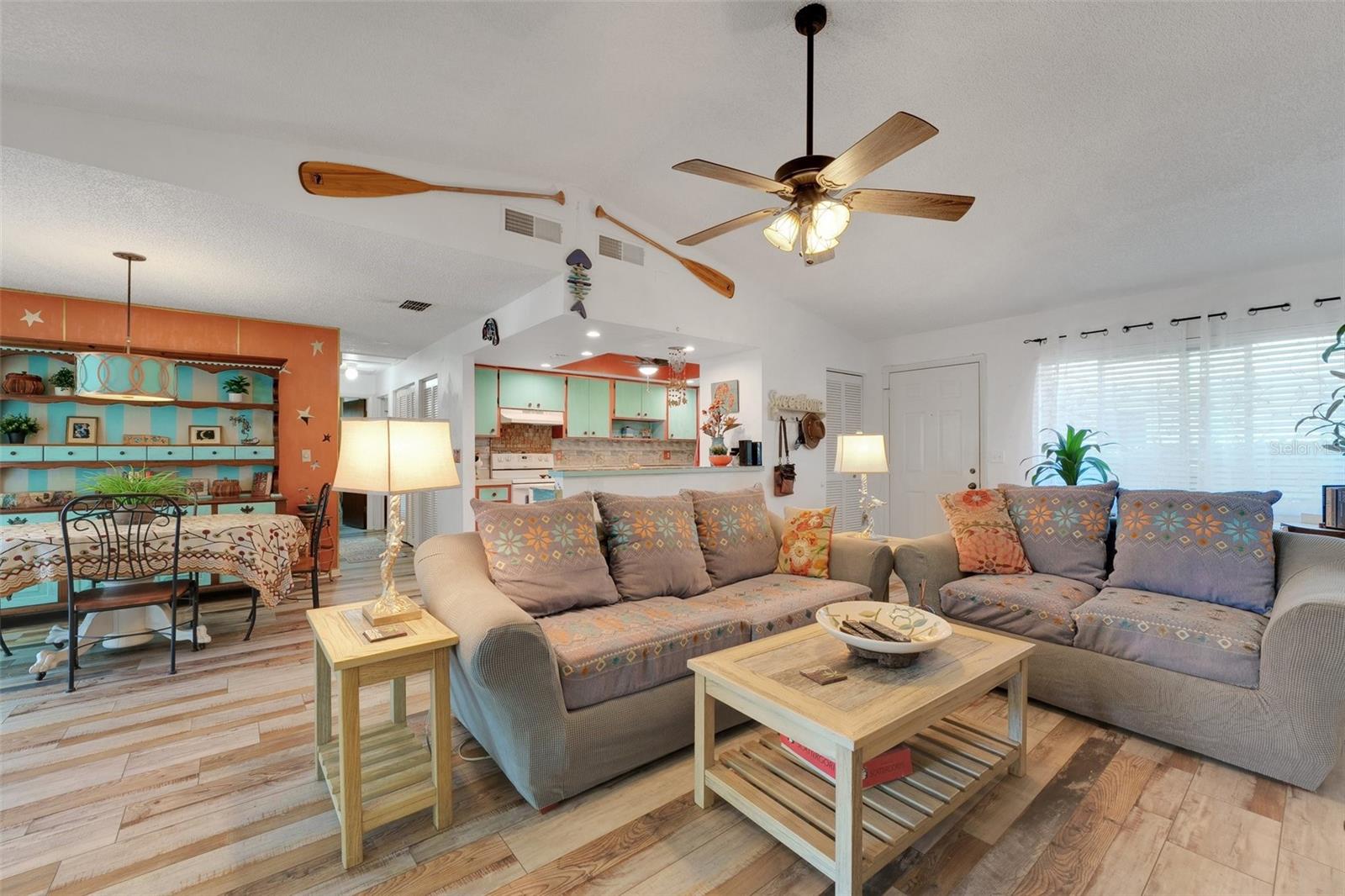 This bright and spacious main living area offers a seamless flow into the adjoining dining room and kitchen, creating an open-concept feel that’s perfect for both relaxing and entertaining.