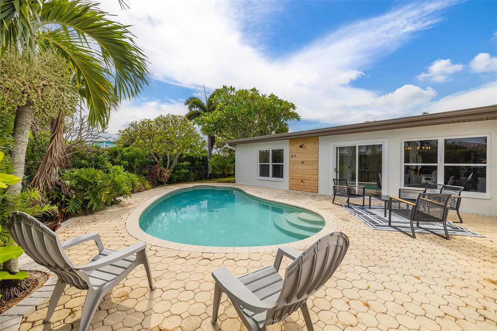 Pool with pavers and outdoor shower