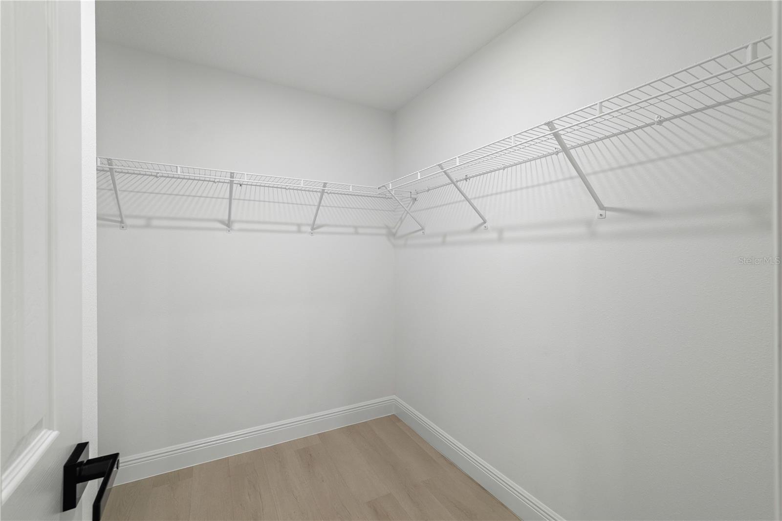 Primary bedroom walk in closet