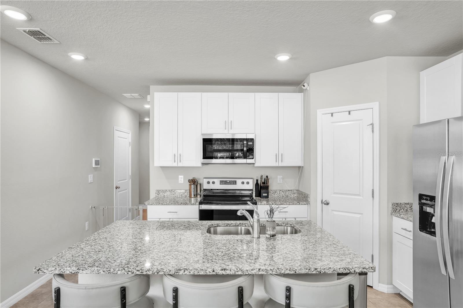 White shaker cabinets with granite countertops