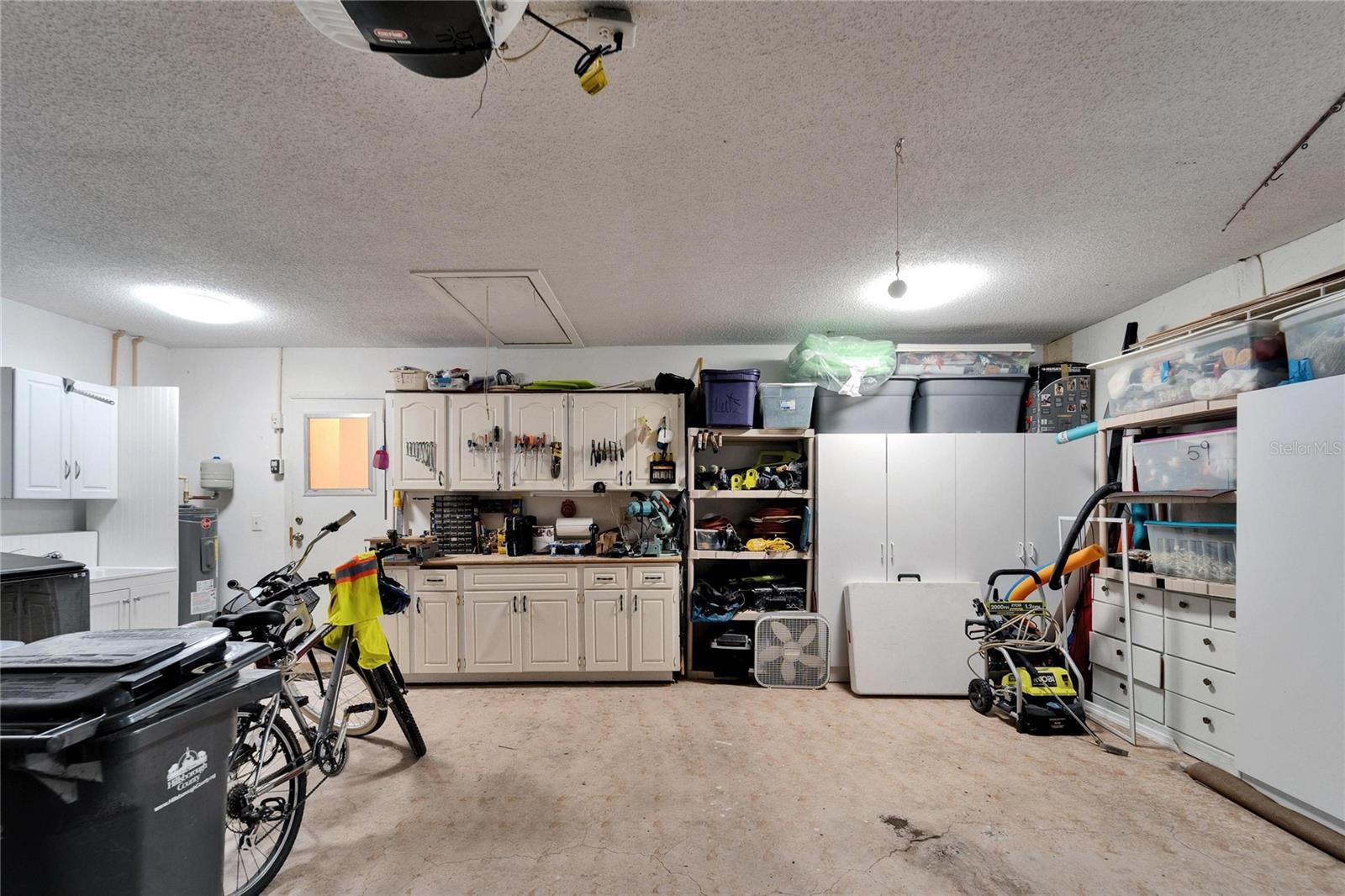 There is a work bench and a craft bench in the garage