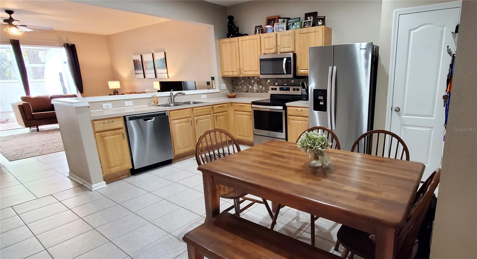 Stainless Steel appliance package PLUS Tile Backsplash PLUS Brushed Nickel hardware complete the look of this kitchen!