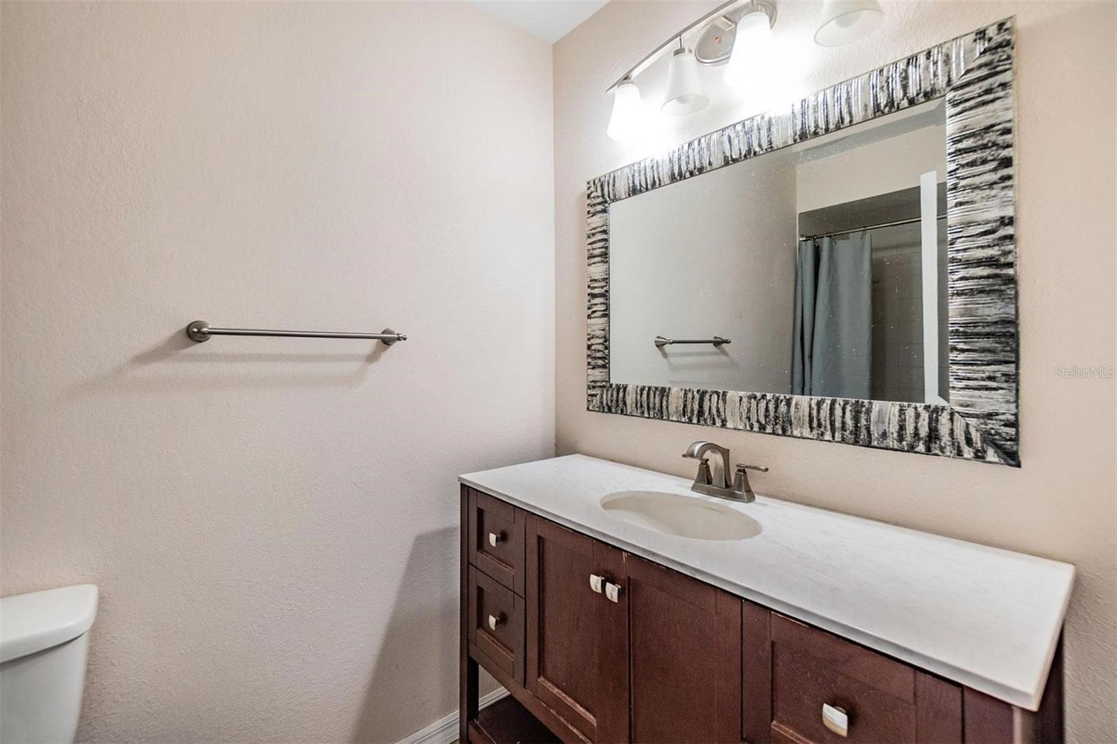 Second bathroom with stylish vanity and shower/tub