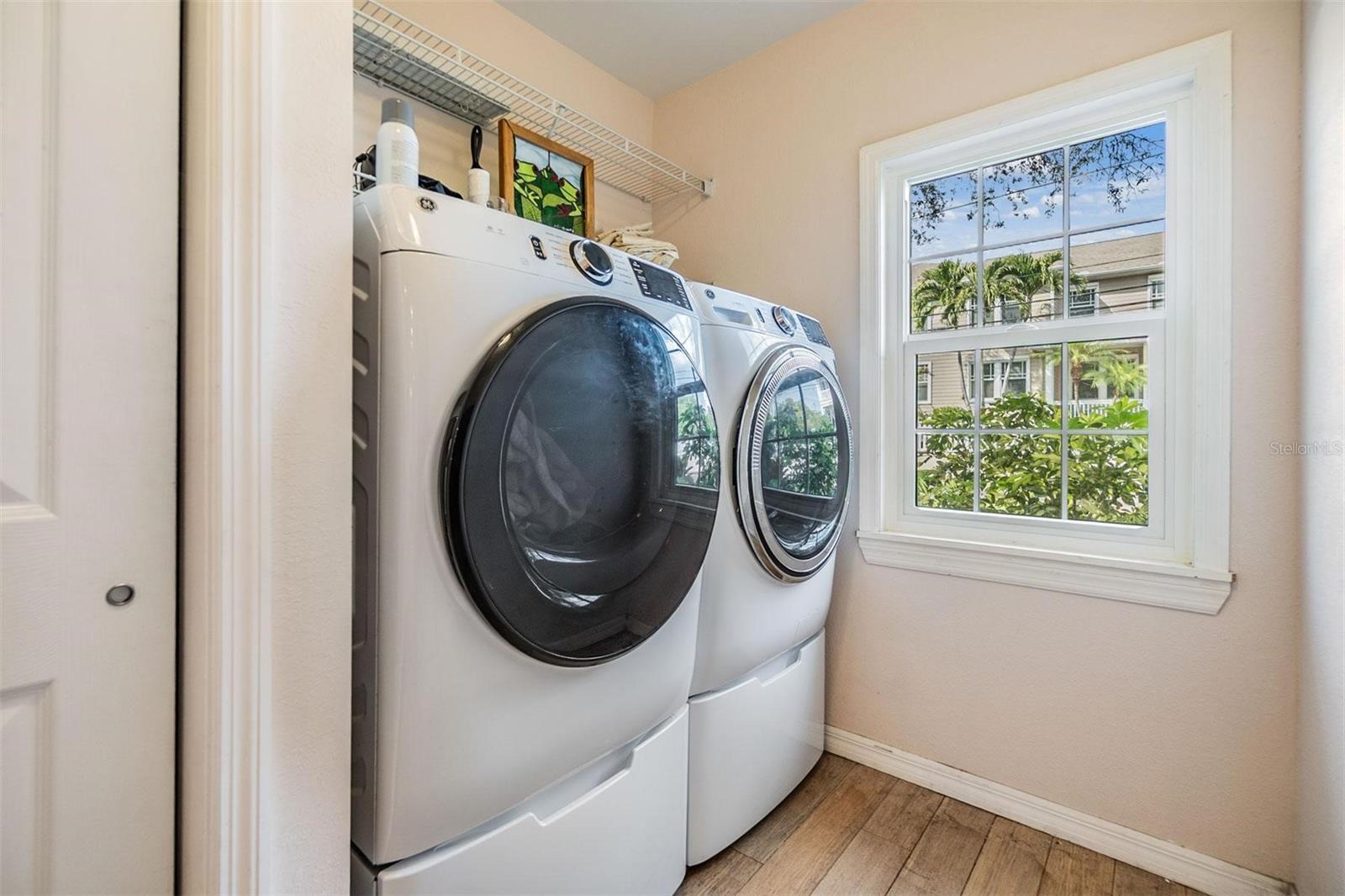 Laundry room with newer front load washer and dryer and storage closet