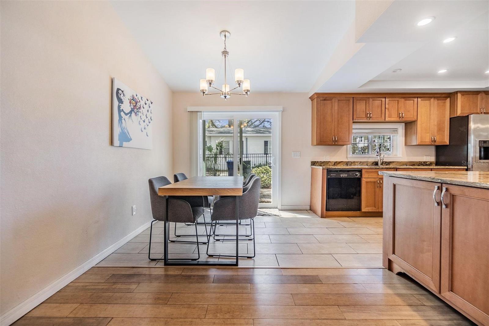 Dining area off the kitchen with glass sliders out the the back patio and flows into the living room perfect for entertaining.