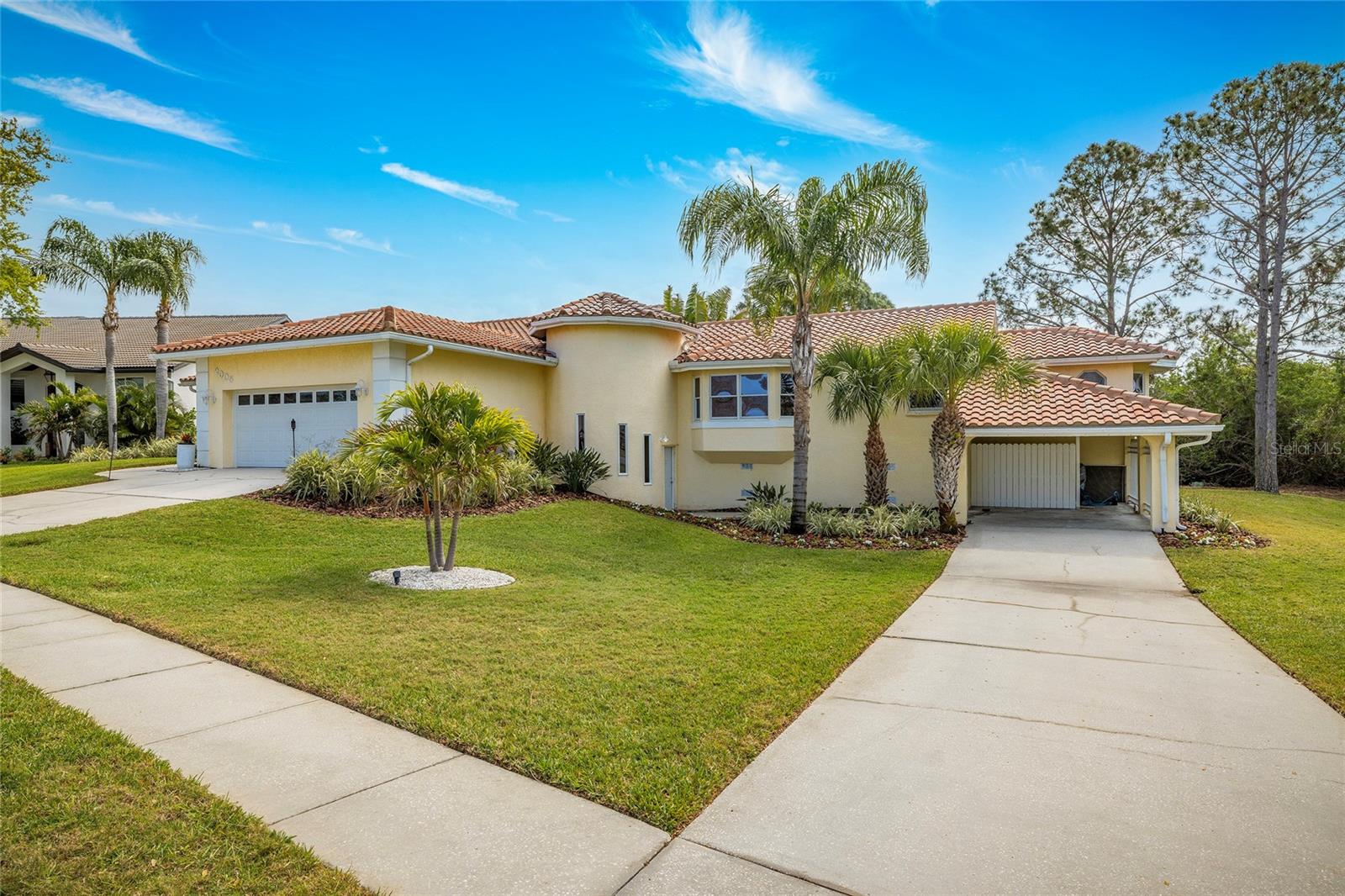 Front of home, two driveways (2 car garage and 2-space carport)