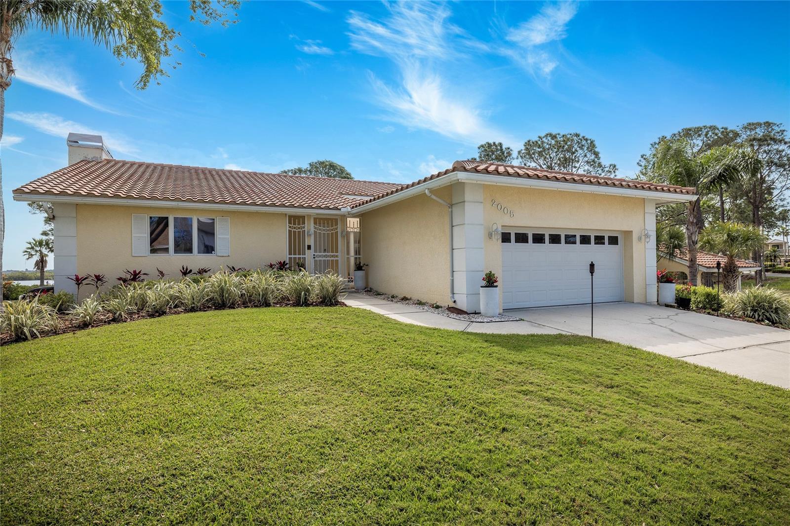 Front of home, two driveways (2 car garage and 2-space carport)