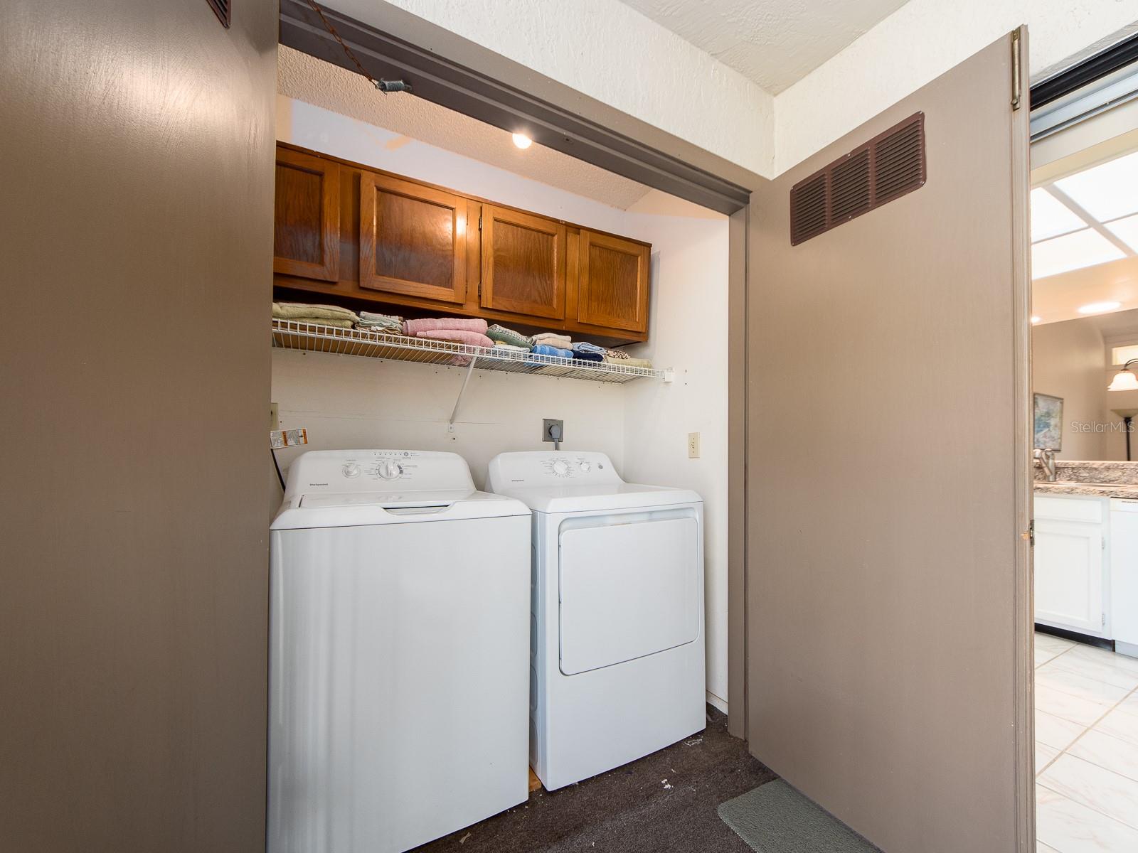 LAUNDRY ROOM WITH CABINETRY AND SHELVING