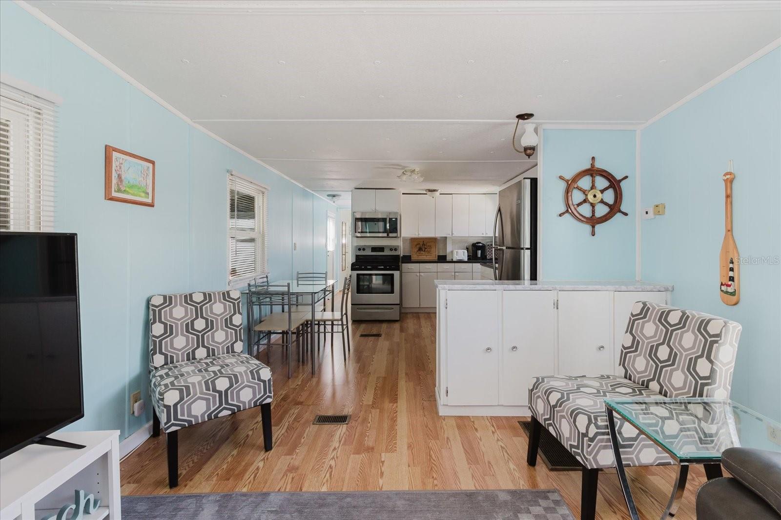 Open Concept Main Living Area with Laminate Floors Furniture Stays