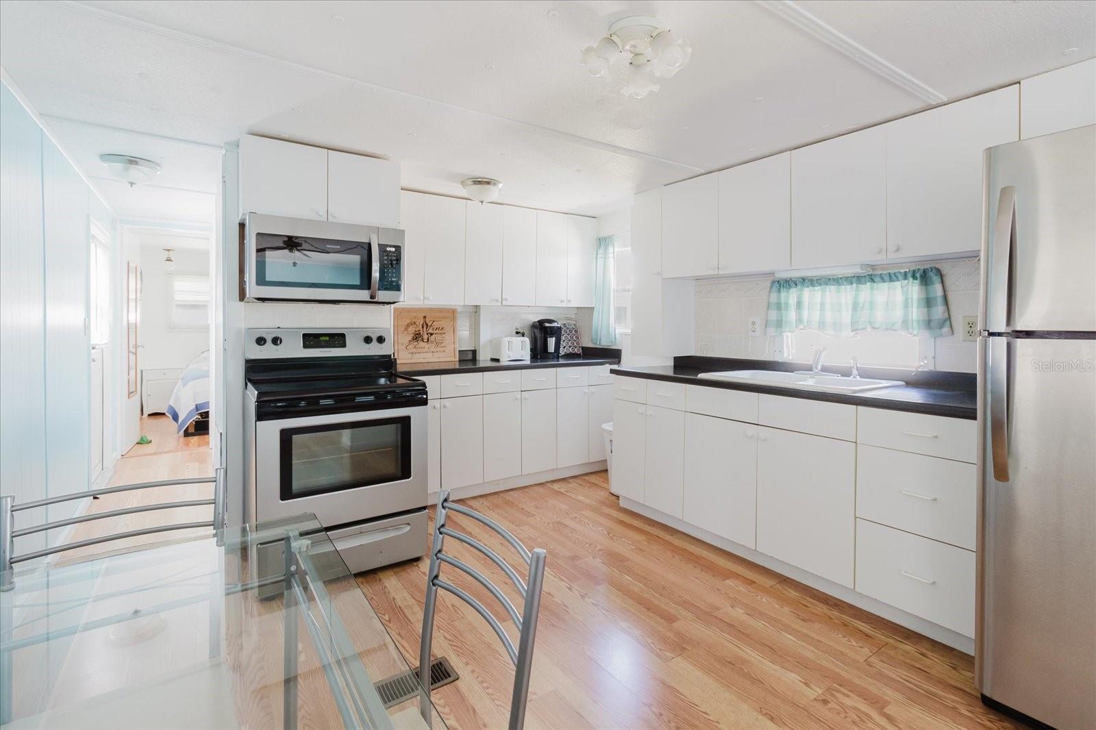 Open Concept Kitchen With Stainless Steel  Appliances and Eat In Kitchen